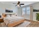 Bedroom is virtually staged and features windows, a ceiling fan and a big bed at 248 Windmill Croft Dr, Las Vegas, NV 89148