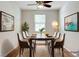 Elegant dining room with modern chairs, art, and a ceiling fan at 248 Windmill Croft Dr, Las Vegas, NV 89148