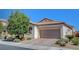 Single-Gathering home featuring a paver driveway, attached garage, and manicured landscaping at 248 Windmill Croft Dr, Las Vegas, NV 89148