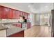 Well-lit kitchen featuring stainless steel appliances, granite counters and wood cabinetry at 248 Windmill Croft Dr, Las Vegas, NV 89148