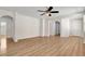 Inviting open living area with arched doorways, ceiling fan, and wood-look flooring at 248 Windmill Croft Dr, Las Vegas, NV 89148