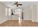 Bright living room with wood floors, ceiling fan, and an open view into the kitchen at 248 Windmill Croft Dr, Las Vegas, NV 89148