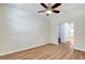 Open living room with a ceiling fan and wood-look flooring at 248 Windmill Croft Dr, Las Vegas, NV 89148