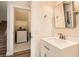 A half bathroom includes a vanity and leads to a laundry room at 251 S Green Valley Pkwy # 1311, Henderson, NV 89012