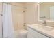 Clean bathroom with marble countertop, bathtub and shower with white shower curtain at 251 S Green Valley Pkwy # 1311, Henderson, NV 89012
