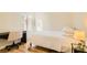 Well-lit bedroom with a cozy bed, desk, and sleek laminate flooring at 251 S Green Valley Pkwy # 1311, Henderson, NV 89012