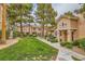 Charming townhome exteriors showcasing lush landscaping, mature trees, and meticulous sidewalk at 251 S Green Valley Pkwy # 1311, Henderson, NV 89012