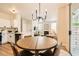 Open-concept dining area with modern chandelier flowing into the living room and kitchen at 251 S Green Valley Pkwy # 1311, Henderson, NV 89012