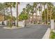 Elegant gated community entrance with lush landscaping and mature palm trees at 251 S Green Valley Pkwy # 1311, Henderson, NV 89012