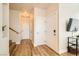 Bright foyer with hardwood floors, white walls, and staircase leading to the upper level at 251 S Green Valley Pkwy # 1311, Henderson, NV 89012