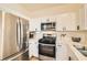 Modern kitchen with white cabinets and stainless steel appliances at 251 S Green Valley Pkwy # 1311, Henderson, NV 89012