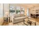 Inviting living room with a sofa, hardwood floors, and view into the dining area at 251 S Green Valley Pkwy # 1311, Henderson, NV 89012