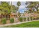 Community pool area featuring ample seating, mature trees and a clubhouse at 251 S Green Valley Pkwy # 1311, Henderson, NV 89012