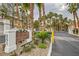 Bella Vista Condominiums community signage with lush landscaping and mature palm trees at 251 S Green Valley Pkwy # 1311, Henderson, NV 89012