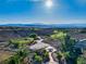 Aerial view showcasing a scenic golf course community with desert landscaping and breathtaking mountain views at 2612 Dearport Ct, Henderson, NV 89052