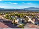 Wide aerial shot displays a residential area, featuring desert landscaping and skyline views in the background at 2612 Dearport Ct, Henderson, NV 89052