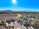 Overhead shot capturing a picturesque community surrounded by a golf course and stunning mountain vistas at 2612 Dearport Ct, Henderson, NV 89052