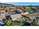 Aerial shot showcasing a desert home with a large backyard, built-in pool, and views of the golf course at 2612 Dearport Ct, Henderson, NV 89052