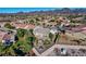 Elevated backyard view, featuring a fenced patio, an outdoor fire pit, and desert landscaping with palm trees at 2612 Dearport Ct, Henderson, NV 89052