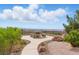 Scenic backyard featuring a stone picnic table, desert landscaping, and beautiful views beyond the fence at 2612 Dearport Ct, Henderson, NV 89052