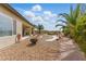 Relaxing backyard with desert landscaping, stone pathways, covered patio, and inviting fire pit at 2612 Dearport Ct, Henderson, NV 89052