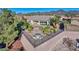 Elevated backyard view, featuring a fenced patio, an outdoor fire pit, and desert landscaping with palm trees at 2612 Dearport Ct, Henderson, NV 89052