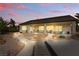 Inviting backyard features a covered patio, desert landscaping, walkways, and lights; perfect for outdoor relaxation and entertaining at 2612 Dearport Ct, Henderson, NV 89052
