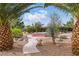 Backyard featuring desert landscaping, palm trees and an inviting red hot tub at 2612 Dearport Ct, Henderson, NV 89052