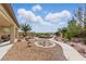 Large backyard with desert landscaping, a rock garden, covered patio and views of the mountains at 2612 Dearport Ct, Henderson, NV 89052