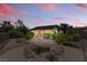 Large backyard patio with stone picnic table and mature landscaping, creating a private and serene outdoor space at 2612 Dearport Ct, Henderson, NV 89052