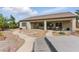 Expansive backyard with desert landscaping, stone pathways, covered patio, and outdoor seating at 2612 Dearport Ct, Henderson, NV 89052