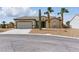 Single story home featuring desert landscaping, a two-car garage, and a tiled roof at 2612 Dearport Ct, Henderson, NV 89052