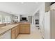 Open concept kitchen with tile floors, bright cabinets and updated appliances overlooking living area at 2612 Dearport Ct, Henderson, NV 89052