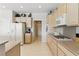 Bright kitchen with a gas range, modern appliances and light wood cabinets at 2612 Dearport Ct, Henderson, NV 89052