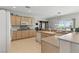 Bright kitchen with a breakfast bar, neutral countertops and ample storage in natural wood cabinets at 2612 Dearport Ct, Henderson, NV 89052