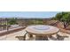 Covered patio featuring a decorative stone picnic table with bench seating and distant views at 2612 Dearport Ct, Henderson, NV 89052