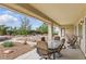 Spacious covered patio with outdoor dining set, sliding glass doors, and landscaped backyard at 2612 Dearport Ct, Henderson, NV 89052