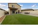 An inviting backyard with an artificial lawn and a patio perfect for entertaining at 2729 Pavehawk Way, Las Vegas, NV 89156