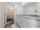 Clean bathroom features double sinks, granite countertops, and a separate shower with a patterned curtain at 2729 Pavehawk Way, Las Vegas, NV 89156