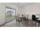 Cozy dining area with a glass table, stylish chairs, and access to the backyard through a sliding glass door at 2729 Pavehawk Way, Las Vegas, NV 89156