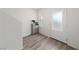Clean entryway featuring laminate flooring, a window, and a convenient shoe storage unit at 2729 Pavehawk Way, Las Vegas, NV 89156