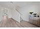 Bright and spacious hallway with laminate flooring, leading to the staircase and other living areas at 2729 Pavehawk Way, Las Vegas, NV 89156