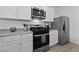 Modern kitchen with stainless steel appliances, white cabinets, and stylish countertops at 2729 Pavehawk Way, Las Vegas, NV 89156