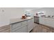 Kitchen island featuring white cabinets, grey counters, and stainless steel appliances in an open floor plan at 2729 Pavehawk Way, Las Vegas, NV 89156