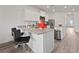 Modern kitchen featuring white cabinets, stainless steel appliances, a breakfast bar, and lots of countertop space at 2729 Pavehawk Way, Las Vegas, NV 89156