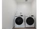 Well-lit laundry room featuring front loading washer and dryer on a light tile floor at 2729 Pavehawk Way, Las Vegas, NV 89156