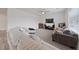 Bright living room with plush sectional, fireplace, and large window at 2729 Pavehawk Way, Las Vegas, NV 89156