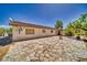 Back of home featuring a covered patio and stone paver landscape at 291 E Hickory St, Pahrump, NV 89048