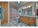 Comfortable bathroom featuring a granite countertop, tile floor, and colorful shower curtain at 291 E Hickory St, Pahrump, NV 89048