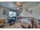 Comfortable bedroom with a ceiling fan, natural light, and desk area at 291 E Hickory St, Pahrump, NV 89048